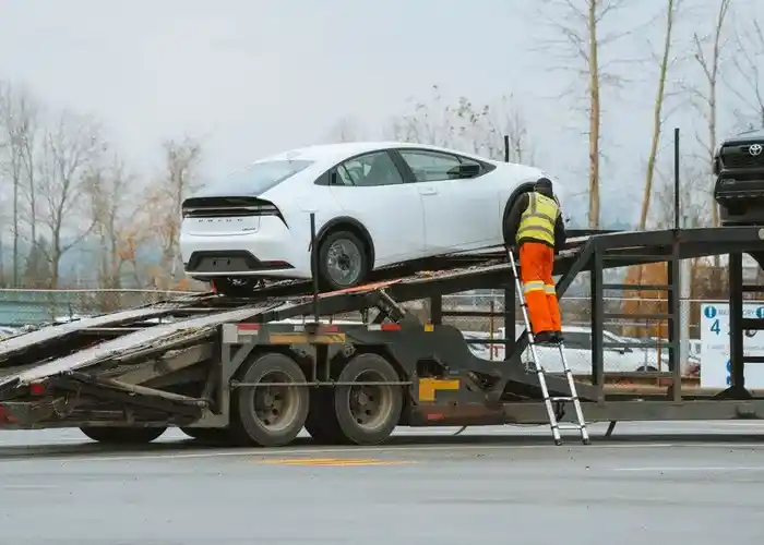 Autoturism încărcat pe platforma de tractare